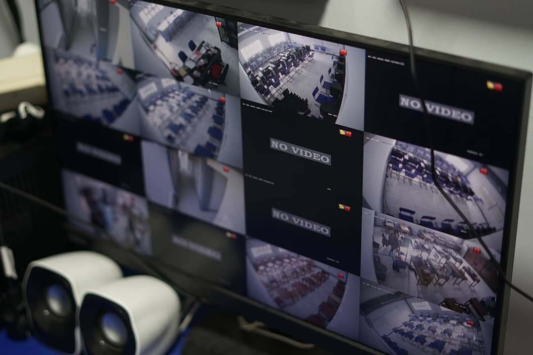 A monitor screen displaying a multi-view of CCTV footage with some units broken and showing no video.